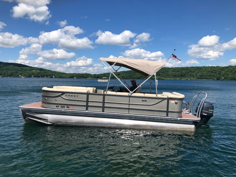 Port view of 23' Crest Pontoon boat with 60 HP Mercury Motor